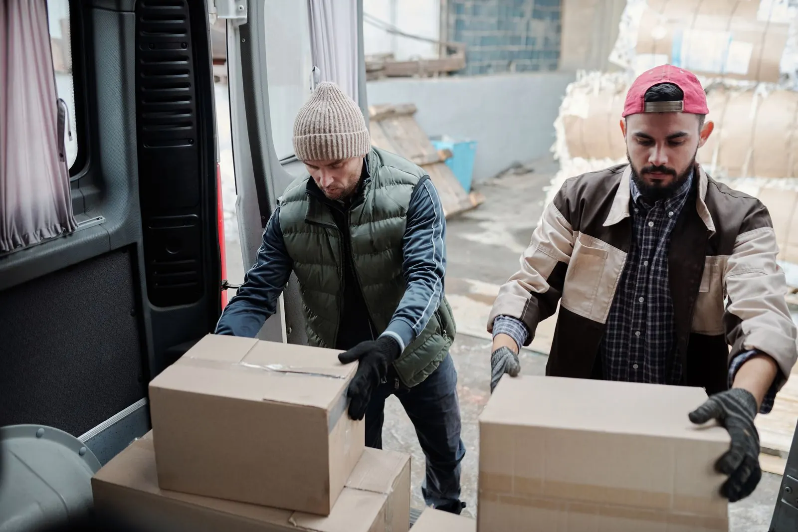 Two-person removal crew loading a van