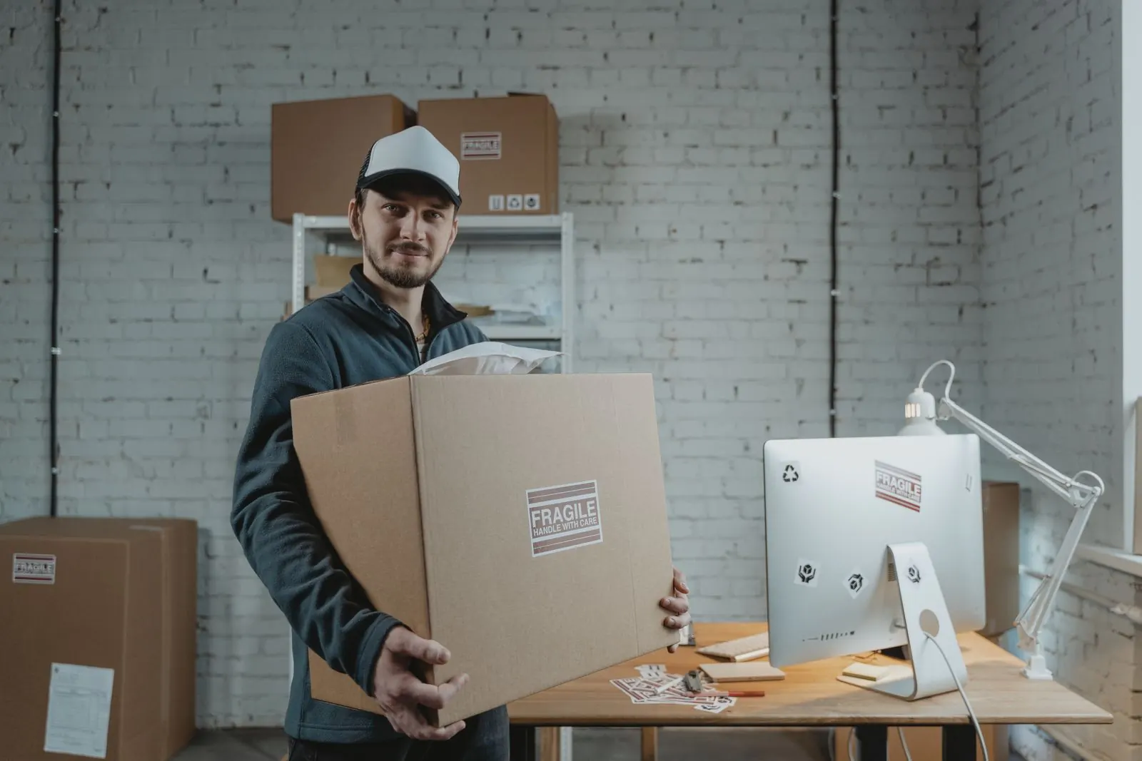Courier delivering boxed IT equipment to an office