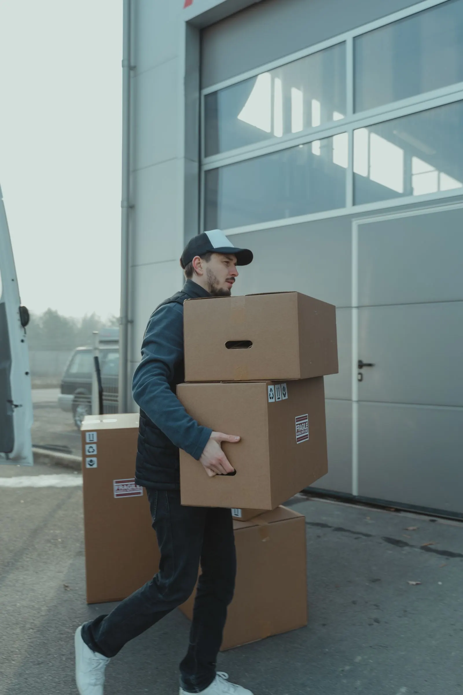 Courier carrying urgent parcels to the van